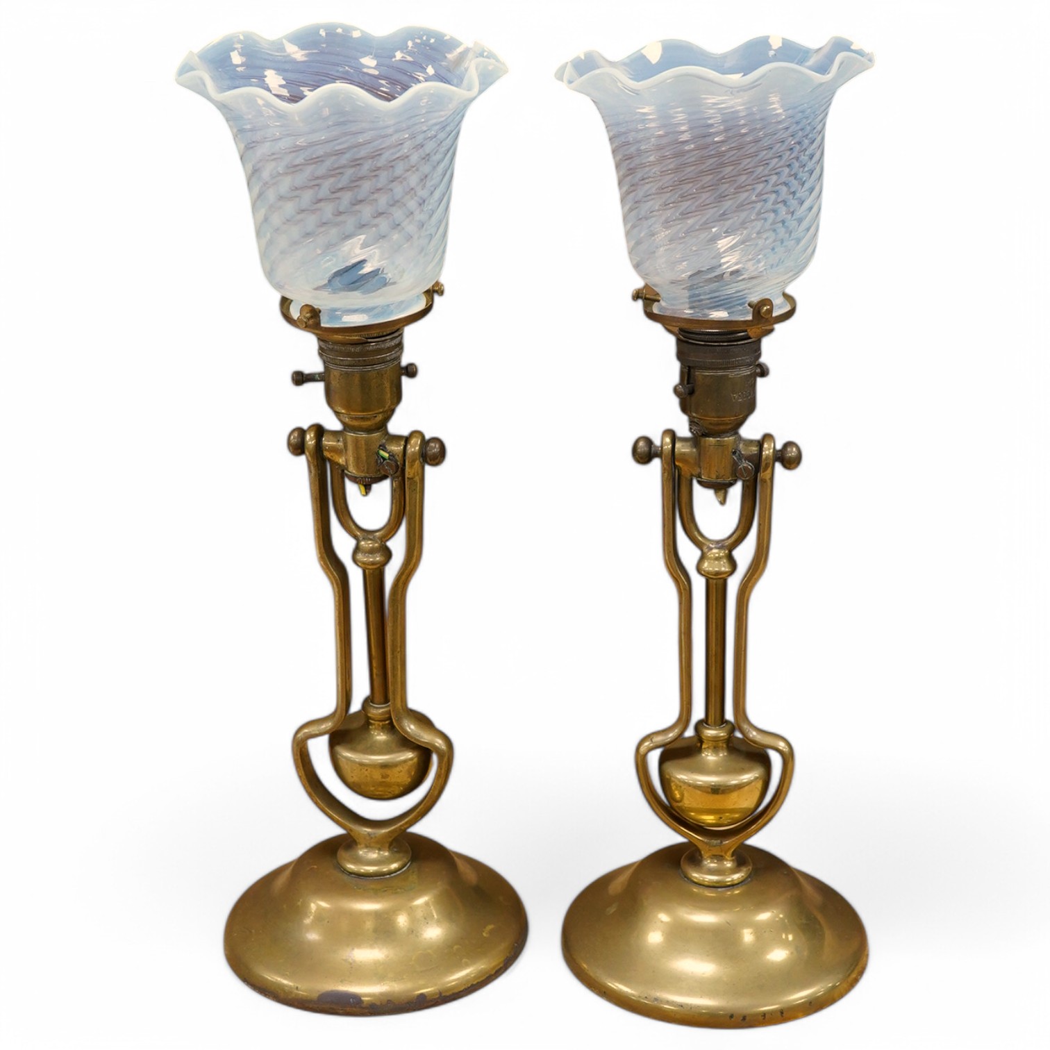 A pair of brass Pullman lamps with gimbal stems and Vaseline glass shades, modelled for wall mounting or freestanding, height to top of shade 40cm. Condition - good